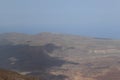 Panoramic view of volcanic lanscape in front of the ocean from the peak of mountain Teide, Tenerife