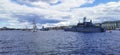 Panoramic view of warships and sailboats in the Neva water area for the Day of the Navy in St. Petersburg against the background
