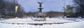 Panoramic view of water fountain covered with fresh winter snow in Central Park, Manhattan, New York City Royalty Free Stock Photo