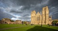 Panoramic view of Wells Cathedral against dramatic stormy sky from Cathedral Green in Wells, Somerset, UK