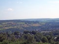 Panoramic view west yorkshire countryside with the village of warley surrounded by woodland and farmland with pennine hills in Royalty Free Stock Photo