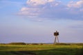 Panoramic view of wetlands covered with early spring green grass, woods and nesting White Stork in Biebrza River wildlife refuge Royalty Free Stock Photo