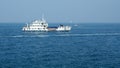 Panoramic view of a white ship (working barge) in the Adriatic Sea. Several sailing yachts in the background.