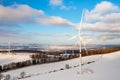 Panoramic view of wind farm or wind park, with high wind turbines for generation electricity