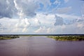 Panoramic views of the coastline on the river Neches in the day and evening time against the blue sky, clouds and sunset.