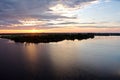 Panoramic views of the coastline on the river Neches in the day and evening time against the blue sky, clouds and sunset.