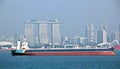 Panoramic views of the port and the city of Singapore during day and night. Kind of cargo and merchant vessels anchored. Royalty Free Stock Photo