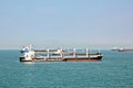 Panoramic views of the port and the city of Singapore during day and night. Kind of cargo and merchant vessels anchored. Royalty Free Stock Photo