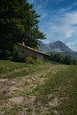 Panoramic views in rural surroundings, idyllic mountain landscape with rural stone house, many trees and blue sky. VegabaÃÂ±o Royalty Free Stock Photo