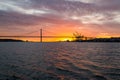 Panoramic views of the Tagus River, Bridge April 25 Lisbon and port at sunset from ship, Portugal. Royalty Free Stock Photo