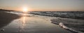 Panoramic warm evening sunset on the Black Sea coast with waves and foam of violent waves