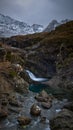 Panoramic waterfall and snow-capped mountains. loose stones in the foreground and turquoise water - Fairy Pools - Skye Island - Royalty Free Stock Photo