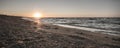 Panoramic waves of the Black Sea on the shore on the beach at a warm sunset and a rough sea with waves of foam and warm water Royalty Free Stock Photo