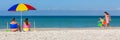 Happy family parents and children having fun in deck chairs on a beach Royalty Free Stock Photo