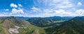 Panoramic wide banner view of a Chike-Taman pass in the Altai mountains with green trees, Blue sky and clouds Royalty Free Stock Photo