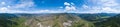 Panoramic wide banner view of a Chike-Taman pass in the Altai mountains with green trees, Blue sky and clouds Royalty Free Stock Photo