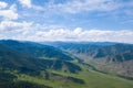 Panoramic wide banner view of a Chike-Taman pass in the Altai mountains with green trees, Blue sky and clouds Royalty Free Stock Photo