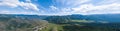 panoramic wide banner view of a Chike-Taman pass in the Altai mountains with green trees, Blue sky and clouds Royalty Free Stock Photo