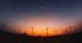 panoramic of Wind turbine and a solar panel at sunset. Royalty Free Stock Photo