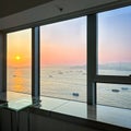 Panoramic windows overlooking beautiful golden sunset in Victoria Harbour, Hong Kong Royalty Free Stock Photo