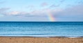 Winter view of Baltic sea with beach and rainbow over maritime horizon offshore Gdynia Orlowo district of Tricity in Poland