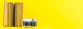 Panoramic yellow background of old analog camera with red book Royalty Free Stock Photo