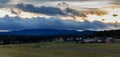 Panoramtic view to sunset clouds on hill Klet with meadow and small village, Czech landscape Royalty Free Stock Photo