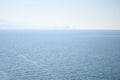 Panoranic view of sea with city on horizin in the haze Royalty Free Stock Photo