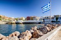 Waving greek flag in village Panormos, Crete island - Greece