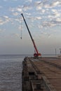 A Panossi Mobile Crane with Jib extended at the end of a Pier in the mouth of the Amazon river Royalty Free Stock Photo