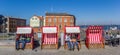 Panrama of people enjoying the sun in raditional beach chairs in Stralsund Royalty Free Stock Photo