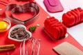 Pans hearts mold, whisk, eggs, wooden spatula and grated chocolate. Ingredients to making festive cake. Valentines Day bakeware