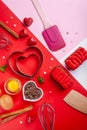 Pans hearts mold, whisk, eggs, wooden spatula and grated chocolate. Ingredients to making festive cake. Valentines Day bakeware Royalty Free Stock Photo