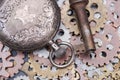 Panta rhei concept: antique pocket watch, old vintage key and hour metallic gears on natural stone Royalty Free Stock Photo