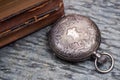 Panta rhei concept: antique pocket watch and pile of vintage hard cover books on natural stone Royalty Free Stock Photo