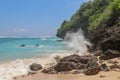 Pantai Gunung Payung beach with fine golden sand, Bali. Turquoise blue water turns into sea foam as the waves break against rocky