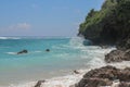Pantai Gunung Payung beach with fine golden sand, Bali. Turquoise blue water turns into sea foam as the waves break against rocky