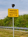 Panther crossing sign on a post