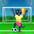 A panther in uniform standing on the ball and cheering with goblet on the soccer field