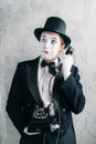 Pantomime actor performing with retro telephone Royalty Free Stock Photo