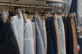 Pants and jeans on the racks in clothing store