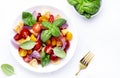 Panzanella summer vegetable salad with stale bread, colorful tomatoes, red onion, olive oil, salt and green basil, white table