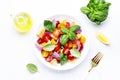 Panzanella summer vegetable salad with stale bread, colorful tomatoes, red onion, olive oil, salt and green basil, white table