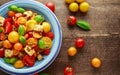 Panzanella Tomato salad with red, yellow, orange cherry tomatoes, capers, basil and ciabatta croutons. summer healthy