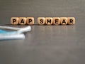 Pap smear text on wooden cubes background. Women health care awareness concept.