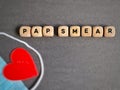 Pap smear text on wooden cubes background. Women health care awareness concept.