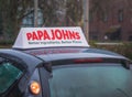 Papa johns pizza sign over a car