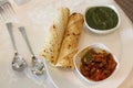 Papad, Chatni, Pickles, Spoons etc arranged in a plate