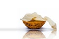 Papad or papadum in a clay bowl isolated on white with its reflection.