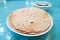 Papadam, Indian snack with green sauce on blue wood background